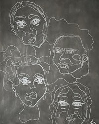 a drawing of four faces on a blackboard